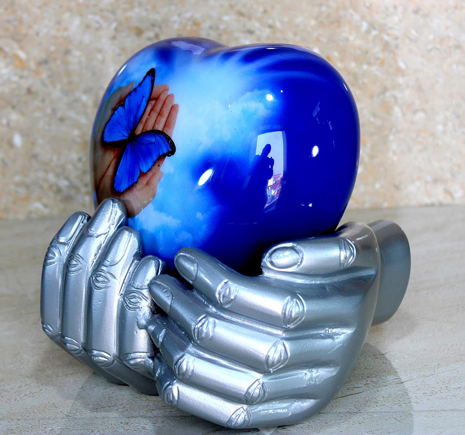 eSplanade Metal Heart-shaped Urn in Hands Stand Cremation Memorial Jar Pot Container | Medium Size Urn for Funeral Ashes Burial | Butterfly Printed Urn | Blue - 6" Inches